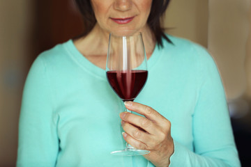 Woman tasting red wine