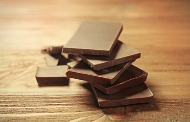 Pile of chocolate slices on wooden background