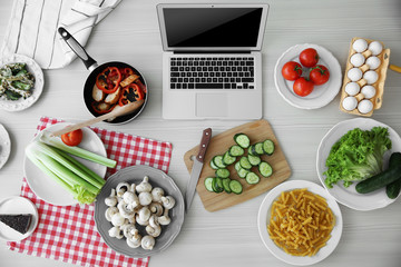 Laptop with ingredients. Food blog concept, top view