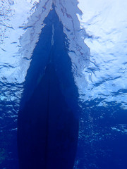 Underwater view of the boat in the sea surface 