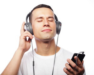 life style and people concept:Young man enjoying music on his he