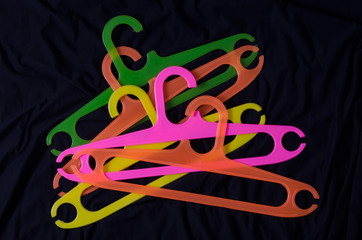 High Angle View Of Multi Colored Coathanger On Fabric