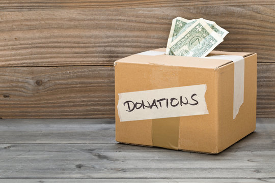 Donation cardboard box with dollar banknotes