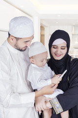 Arabic boy and parents use cellphone