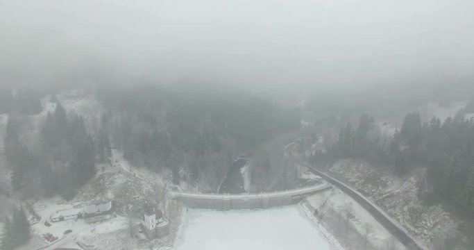 Aerial: The reservoir and bridge of Spindler Mill, Czech Republic in winter