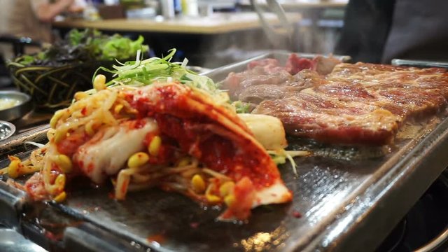 Traditional Korean barbecue and side dishes vegetable food. Grilled on big stone plate 