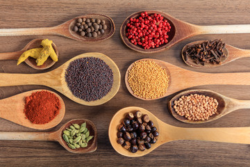 Variety of spices on a wooden surface