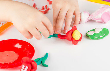 Child hands  with colorful clay