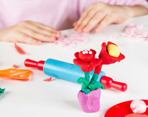 Child hands  with colorful clay