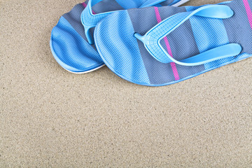 Colored sandal slipper on a summer sand