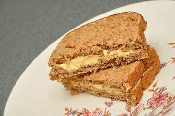 A cheese spread whole wheat sandwich on a plate
