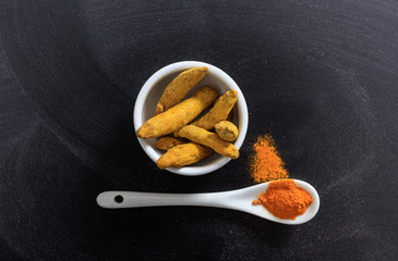 Turmeric in porcelain bowl and spoon