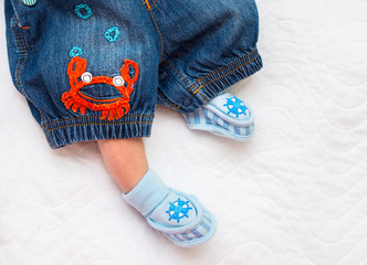 booties on the feet of the newborn in a marine style