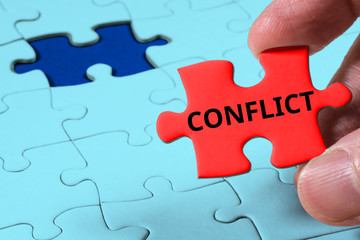 Fototapeta premium Close up of Red jigsaw puzzle with Conflict word