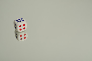A dice that is reflection onto a white background