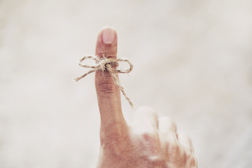 String tired around finger, selective focus, soft focus vintage tone