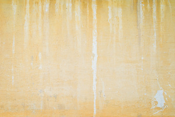 Weathered and aged orange concrete wall, paint peeled off, texture background with vignetting.