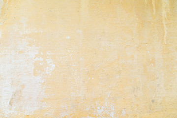 Weathered and aged orange concrete wall, paint peeled off,  texture background.