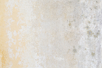 Weathered and aged concrete wall, paint mostly peeled off.