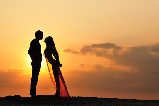 silhouette of a girl and boy at sunset