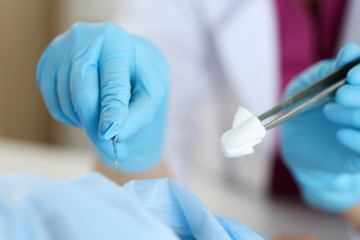 Surgeon hand hold scalpel and tweezers