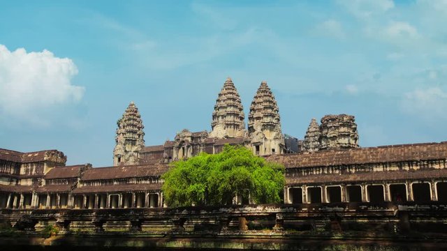 4k video - Passing the front face of Angkor Wat Temple in Cambodia. Time-lapse recording reveals surreal motion of people walking at superspeed.