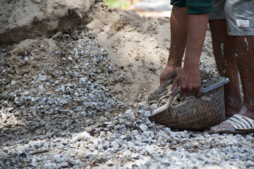 worker picking gravel for construction