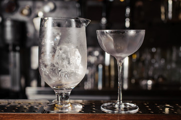 glass with ice on the bar