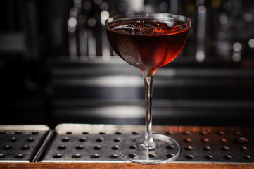 dark cocktail on a  bar setting