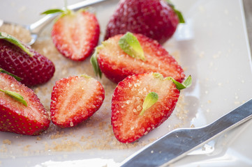strawberries cut with sugar and mint