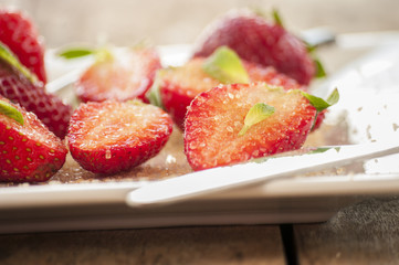 strawberries cut with sugar and mint