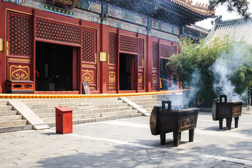 smoking incense sticks in Lama temple, Beijing, China