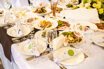 Festive table served with appetizing different food. Party area for wedding celebration.