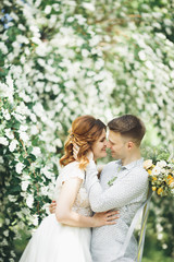 Happy wedding couple walking in a botanical park