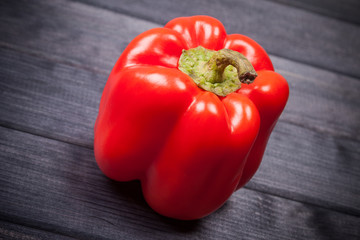 fresh raw red sweet pepper on a wooden table still life