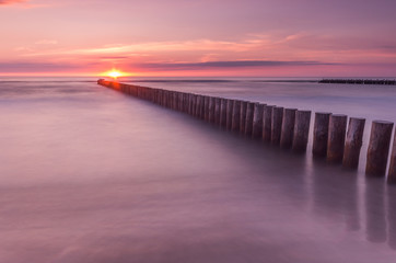 Fototapeta premium Wooden breakwater - Baltic seascape at sunset, Poland