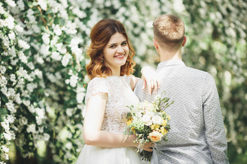 Happy wedding couple walking in a botanical park