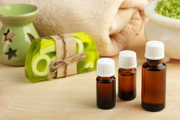 Essential oil, natural soap and aromatic salt on a wooden background. The concept of aromatherapy.