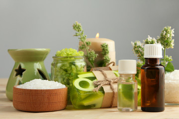 Essential oil, natural soap and aromatic salt on a wooden background. The concept of aromatherapy.