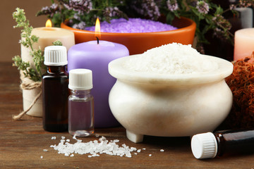 Essential oil with aromatic salt on a wooden background. The concept of aromatherapy.