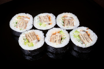 Japanese rolls on black background