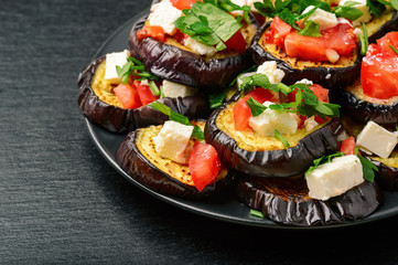 Appetizers - grilled eggplants with garlic, feta cheese and tomatoes.
