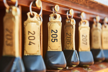 Fototapeta hotel keys with room numbers hanging at reception obraz