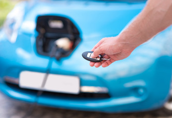 Hand of man holding key for car