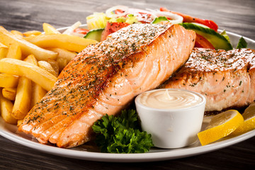 Fried salmon, chips and vegetables