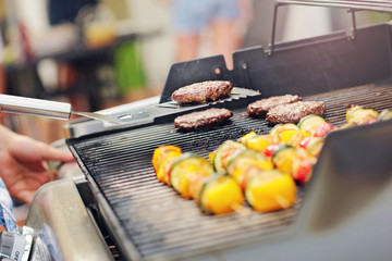 Grilled shashliks and hamburgers on grate