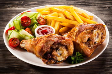 Grilled turkey legs with chips and vegetables