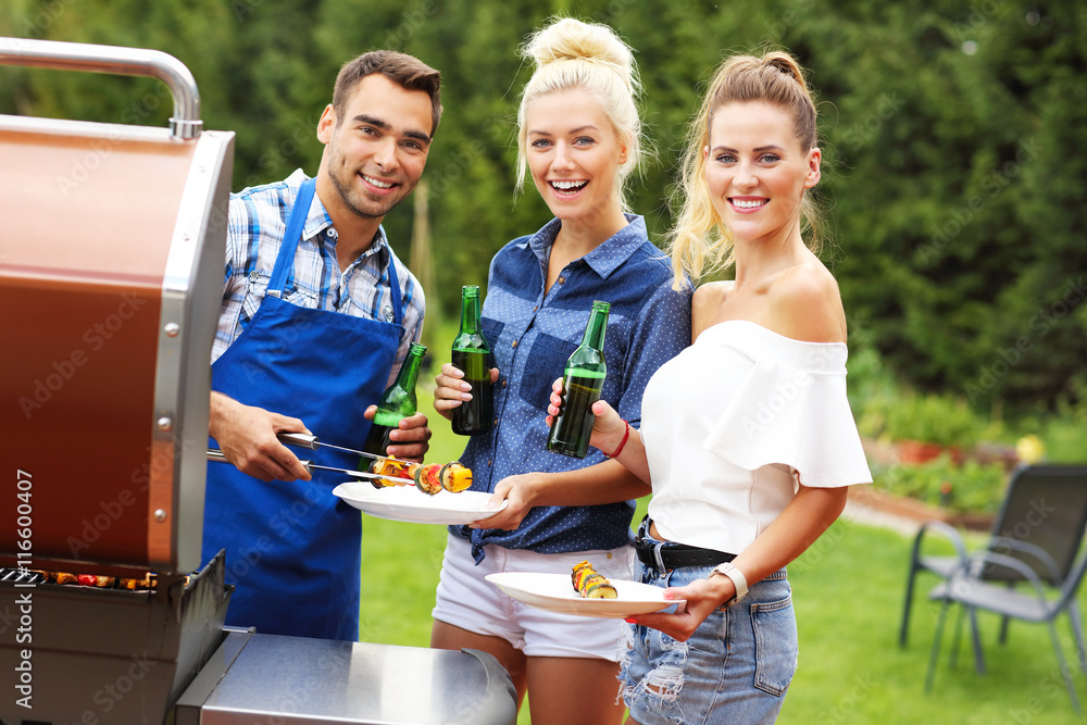 Wall mural group of friends having barbecue party