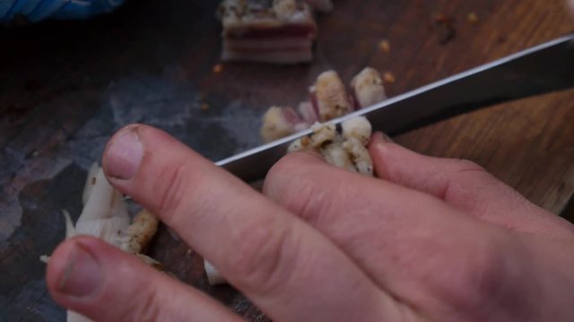 Man's Hand Cuts Pieces of Fat. Traditional Russian Snack for Vodka