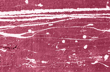 Purple concrete wall with white paint drips, drops and stains